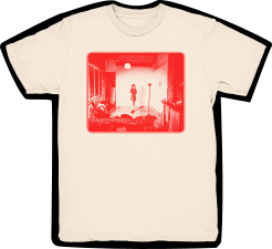 Rowena Wise T-Shirt. The T-Shirt is a cream colour with a red monochrome, screen-printed image of Ro standing in the middle of a small furnished room. The image on the Tee is saturated in the center by a single light in the middle of the room.